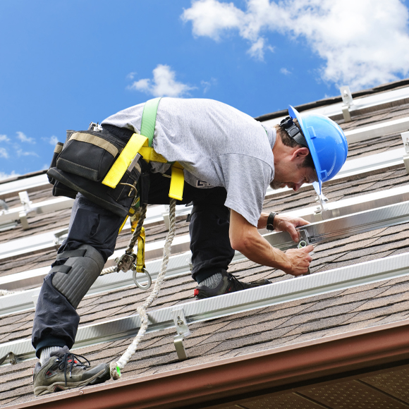 Contractor on roof with business insurance 